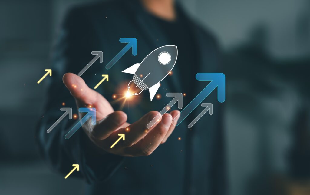 hand holding rocket ship that's blasting upward