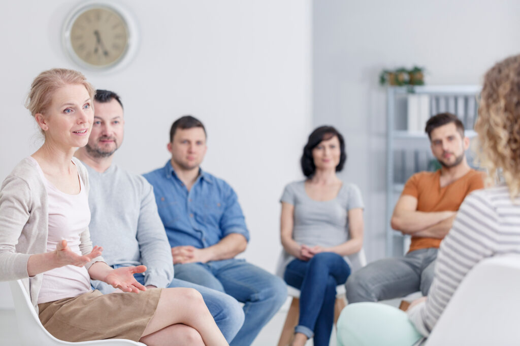 Parents and adult children discussing finances in a home environment with an advisor