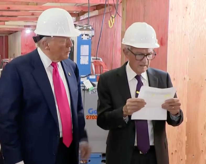 Trump and Powell reviewing a document